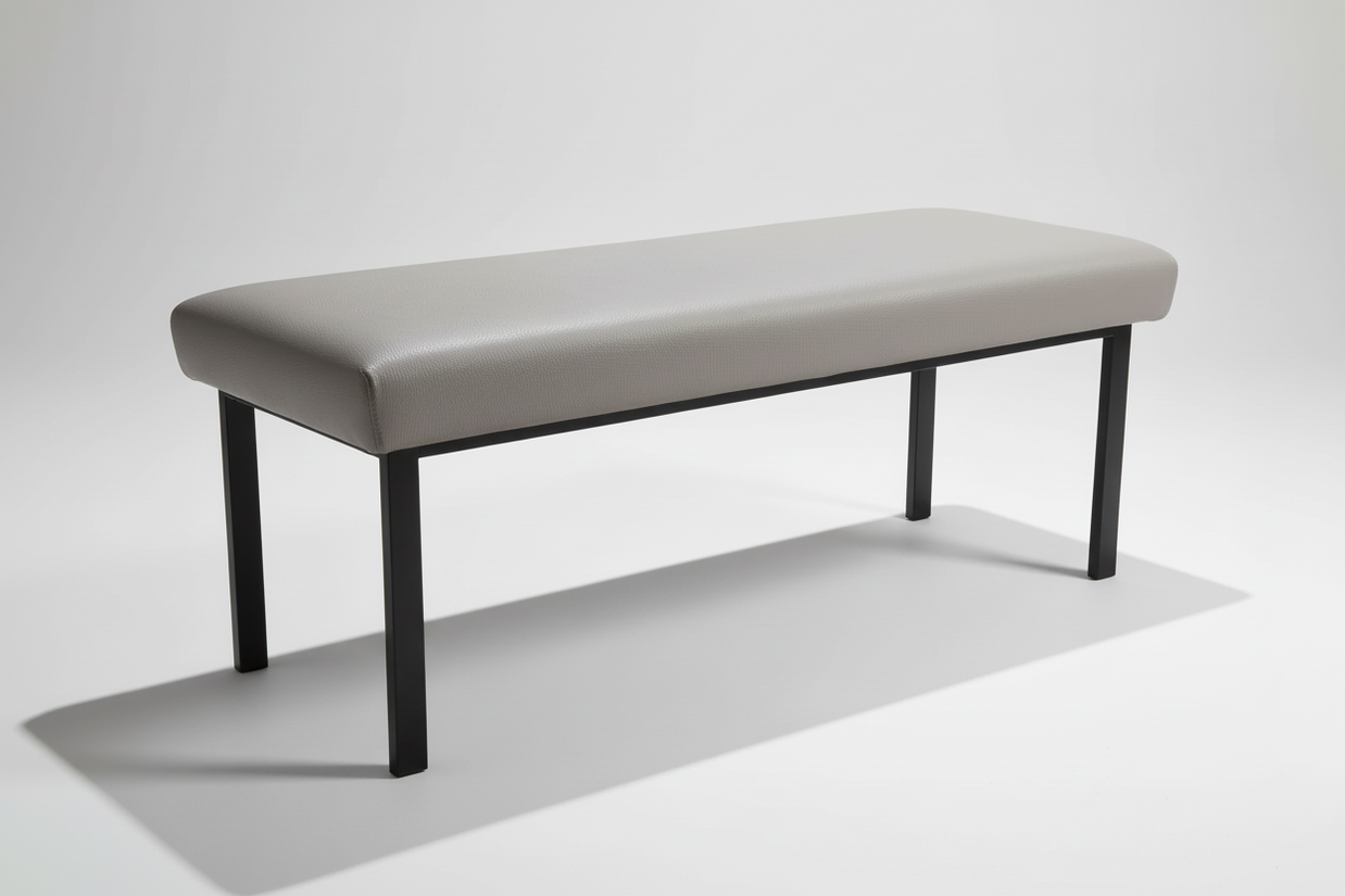 Side view of grey padded bench showing profile and legs