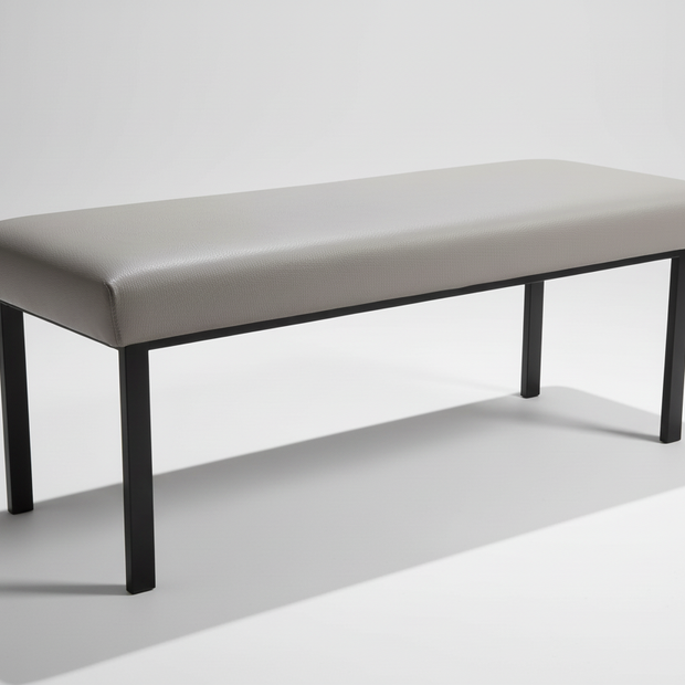 Side view of grey padded bench showing profile and legs