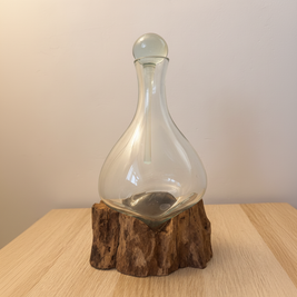 Recycled glass decanter on natural root base